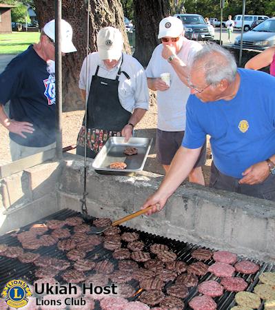 Lion Gary begins pulling burgers off the grill